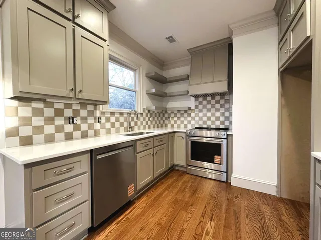 a kitchen with granite countertop a stove and cabinets