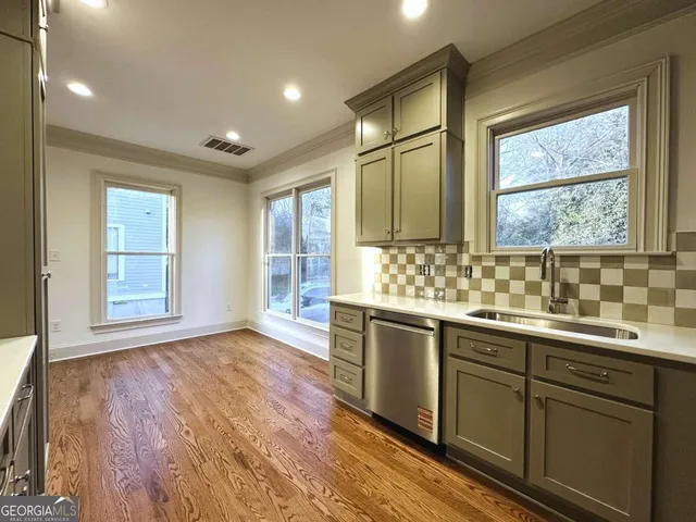 a view of a kitchen counter space and windows
