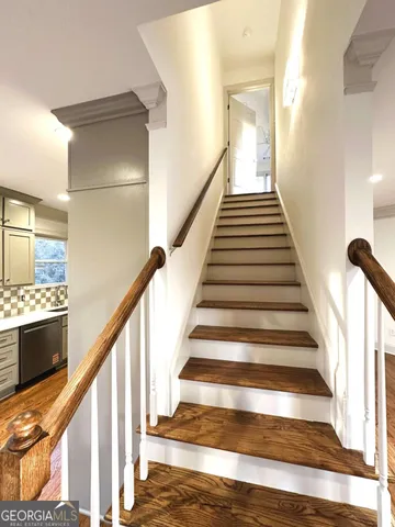 a view of staircase with wooden floor and floors