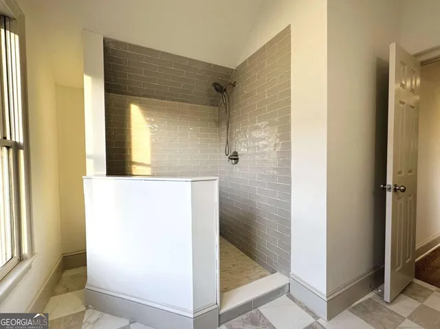 a bathroom with a glass shower door