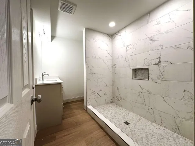 a bathroom with a bathtub and shower
