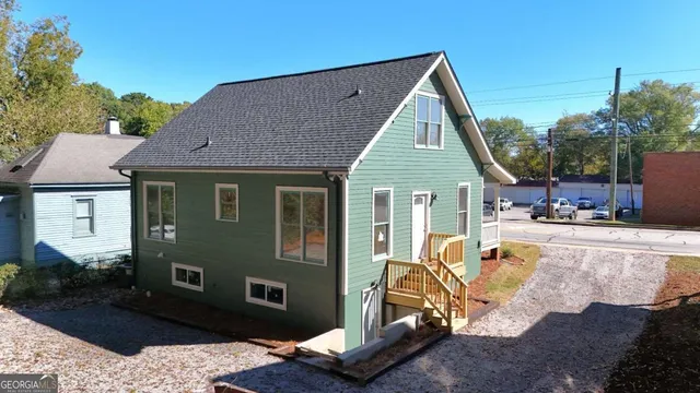 a view of a house with a chairs in patio