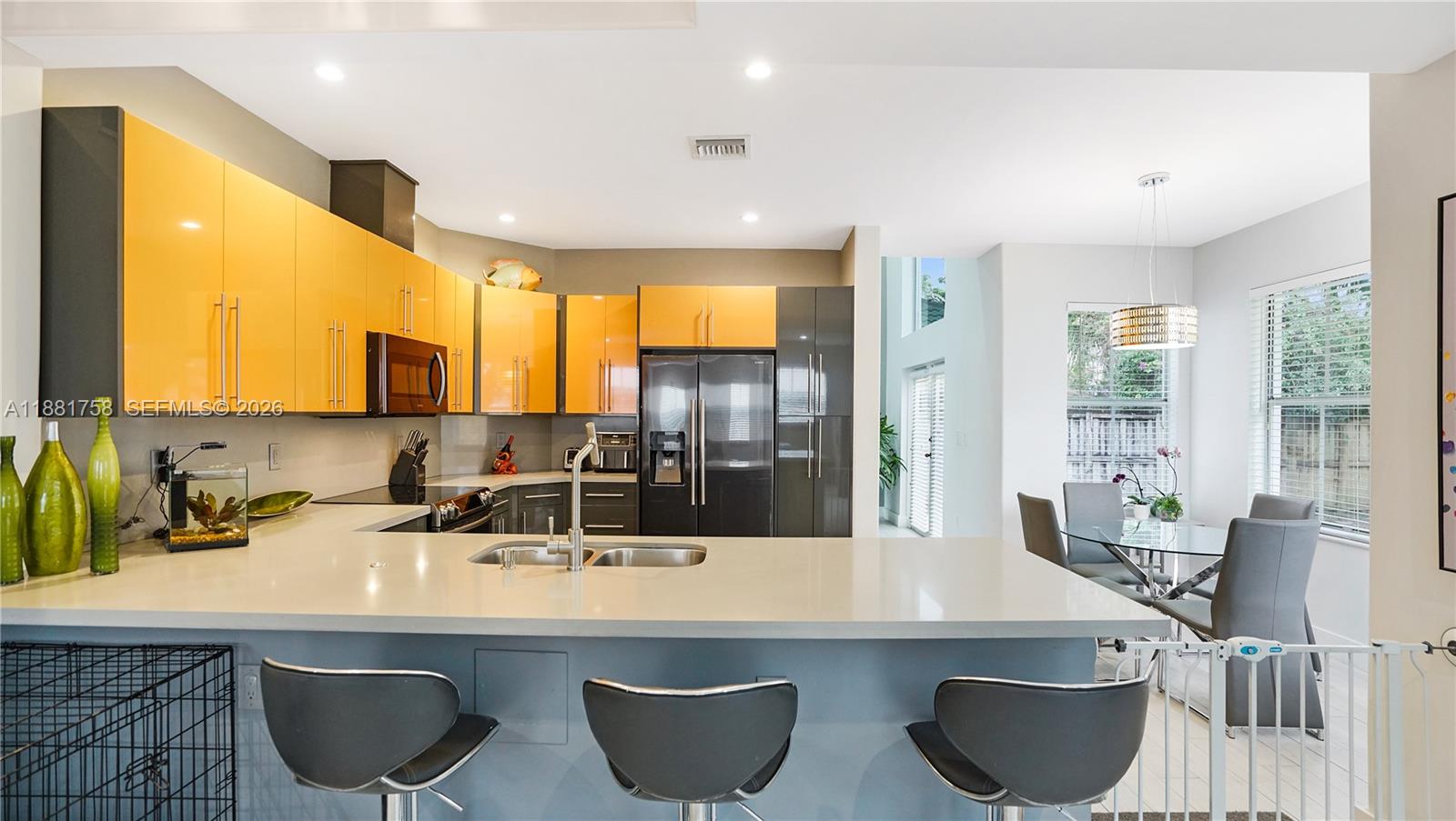 704 Northwest 129th Court Miami, FL 33182 - Photo 11 of 58 a room with granite countertop a sink and a refrigerator