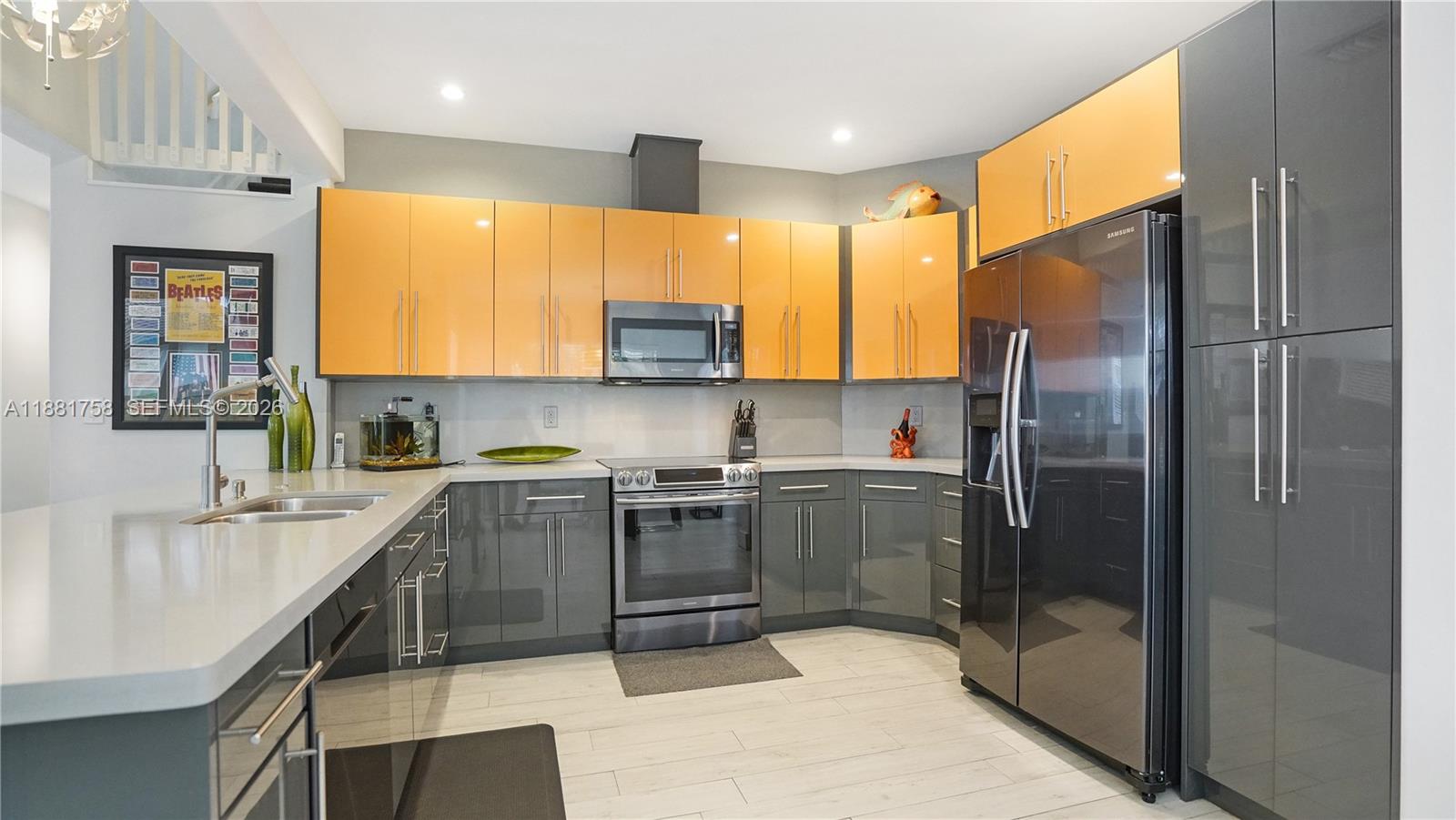 704 Northwest 129th Court Miami, FL 33182 - Photo 12 of 58 a kitchen with stainless steel appliances granite countertop a refrigerator a sink a stove with cabinets