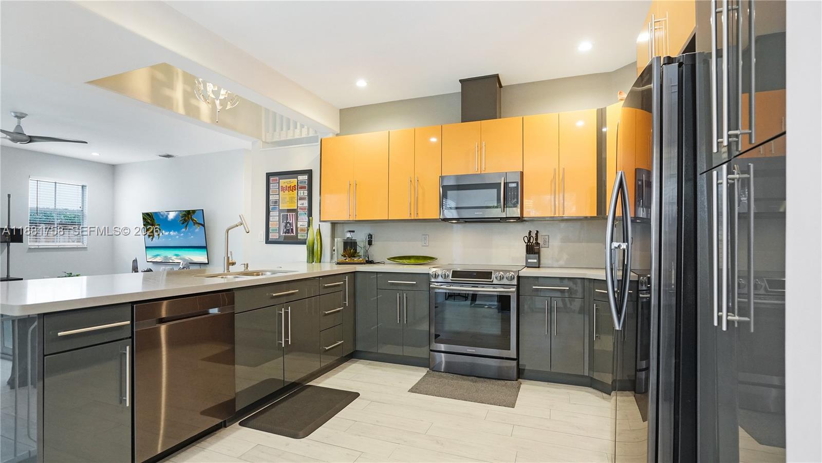 704 Northwest 129th Court Miami, FL 33182 - Photo 13 of 58 a kitchen with stainless steel appliances granite countertop a sink a stove a refrigerator cabinets and a window