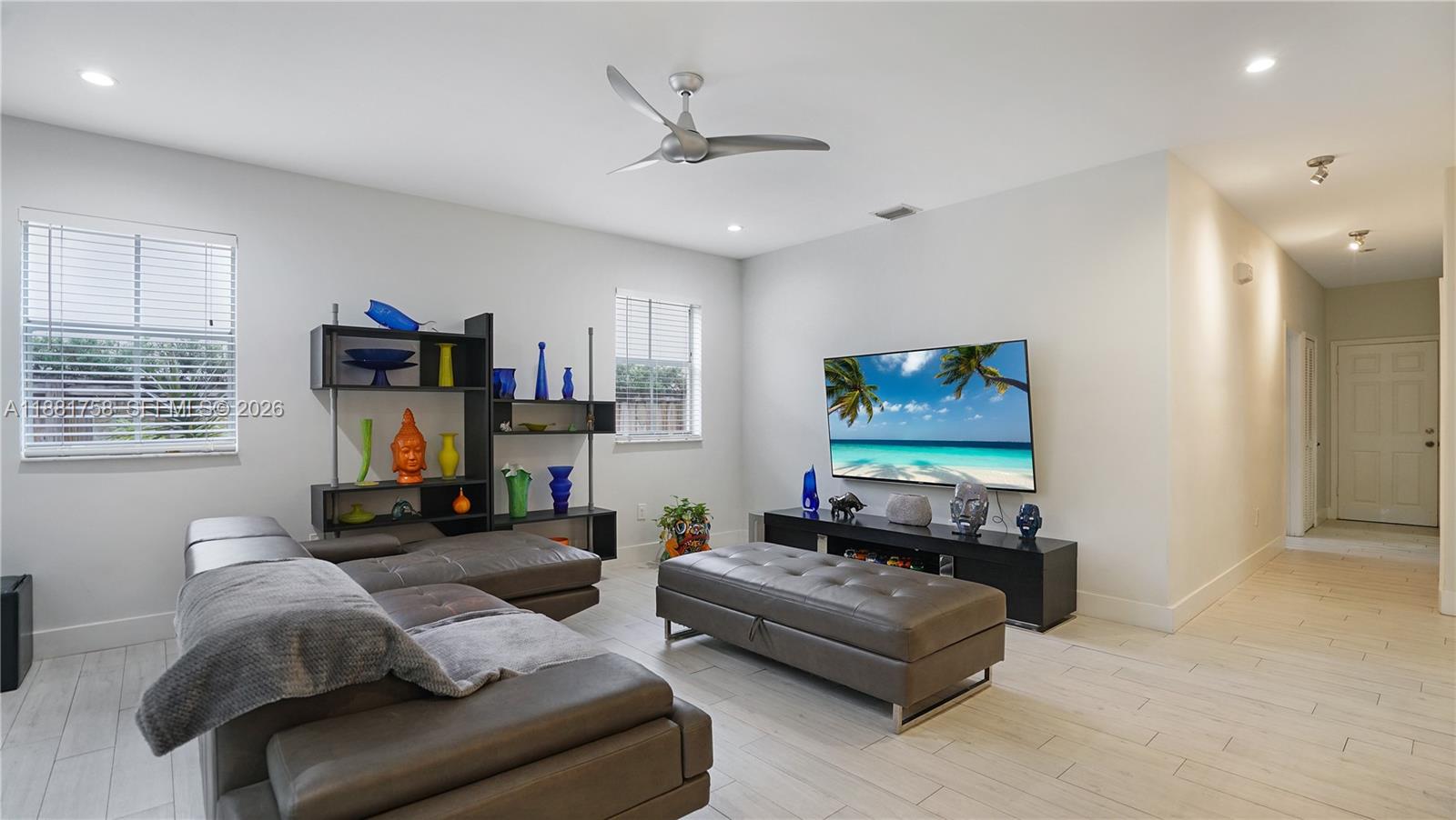 704 Northwest 129th Court Miami, FL 33182 - Photo 17 of 58 a living room with furniture and a flat screen tv