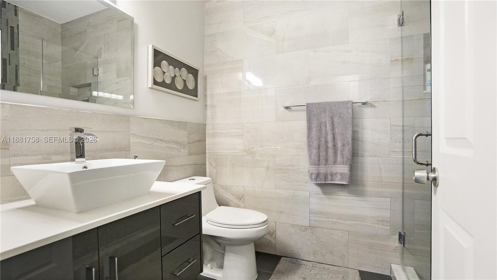 704 Northwest 129th Court Miami, FL 33182 - Photo 19 of 58 a bathroom with a sink a toilet and shower