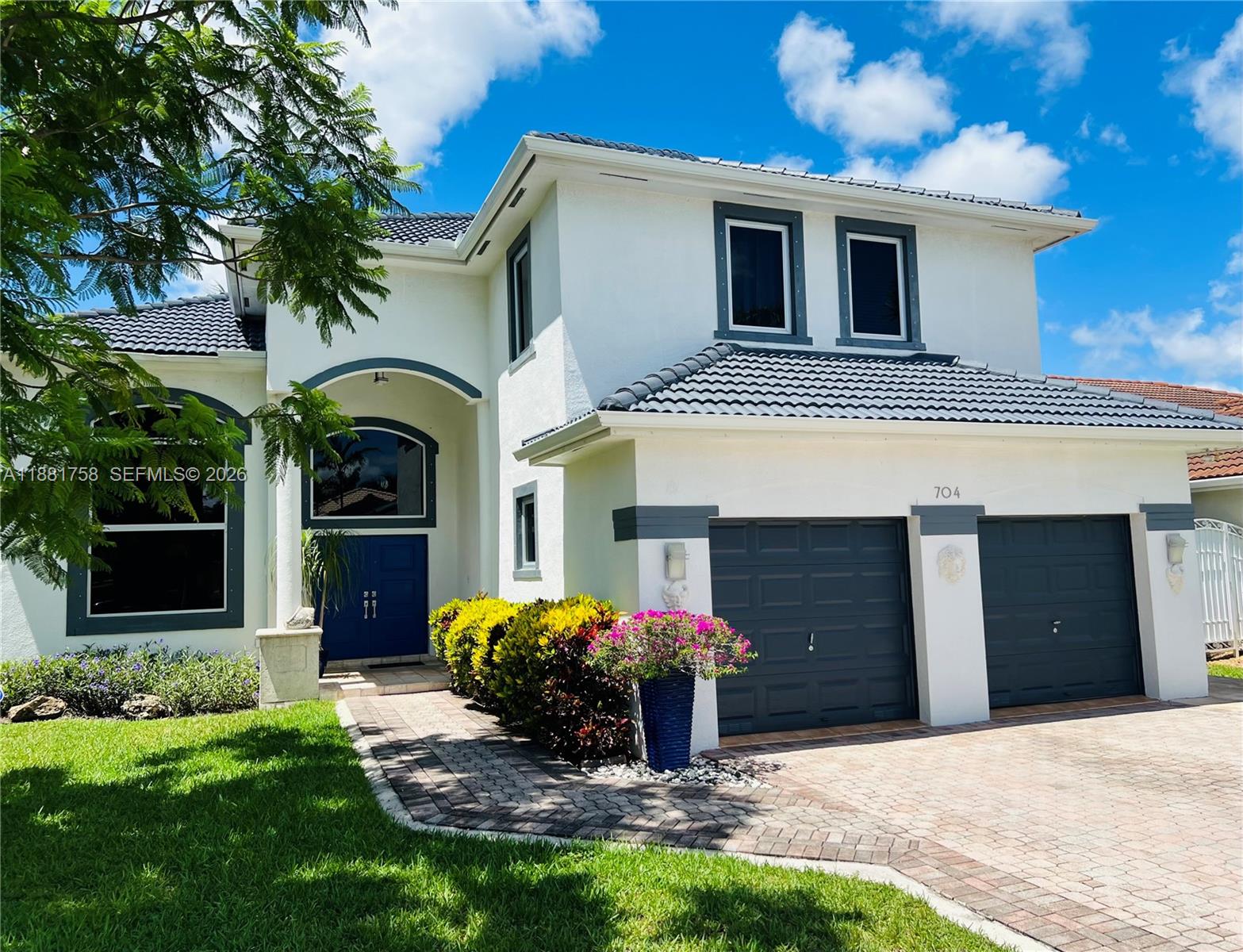 704 Northwest 129th Court Miami, FL 33182 - Photo 2 of 58 a front view of a house with garden