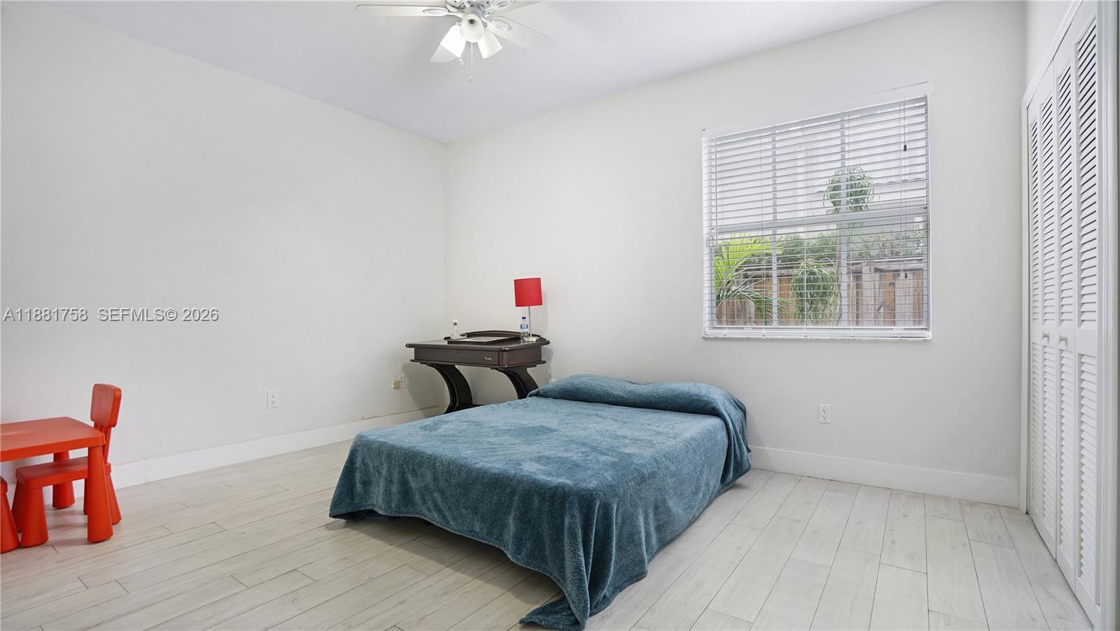 704 Northwest 129th Court Miami, FL 33182 - Photo 22 of 58 a bedroom with a bed and wooden floor