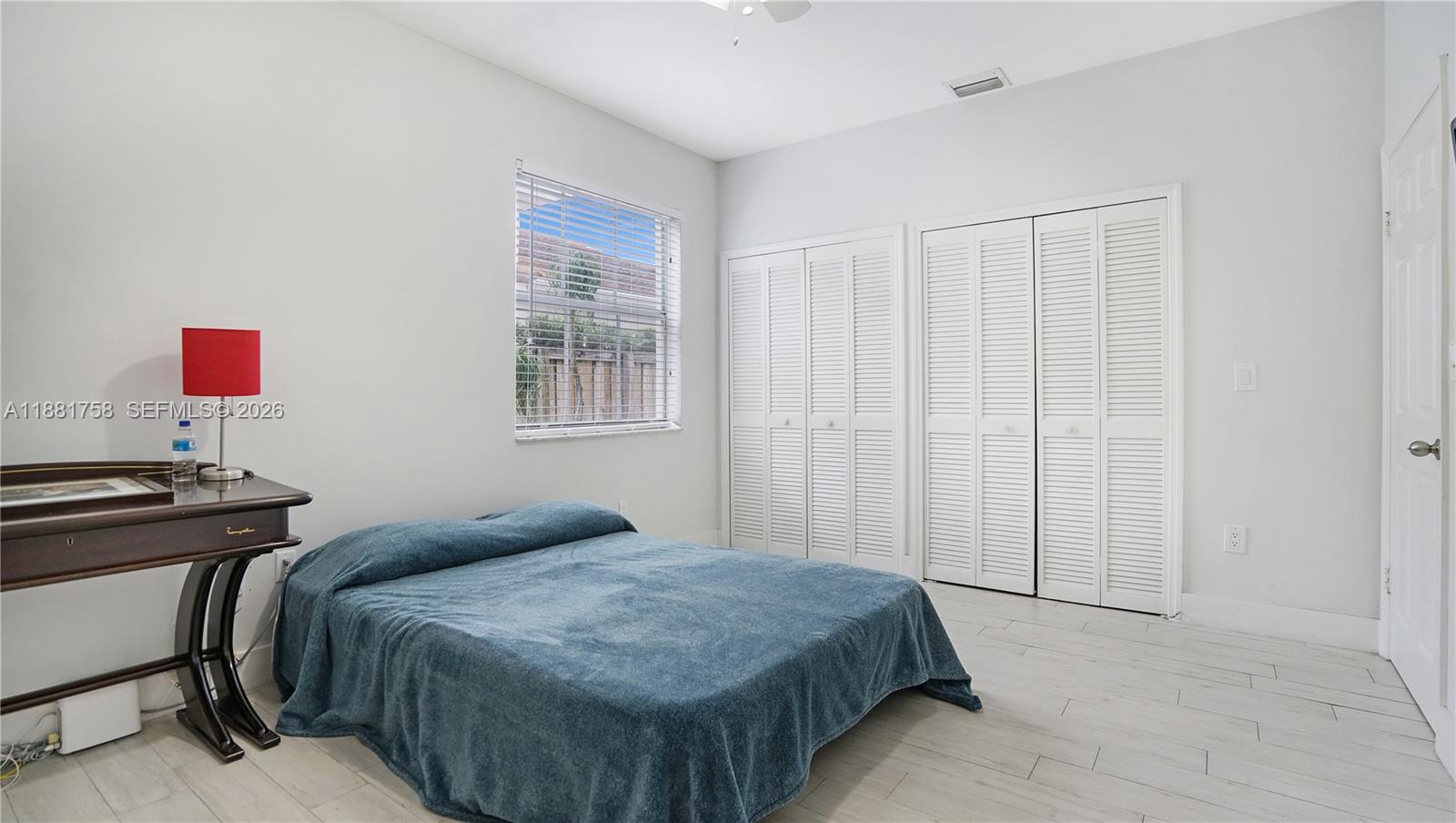 704 Northwest 129th Court Miami, FL 33182 - Photo 23 of 58 a bedroom with a bed and a window
