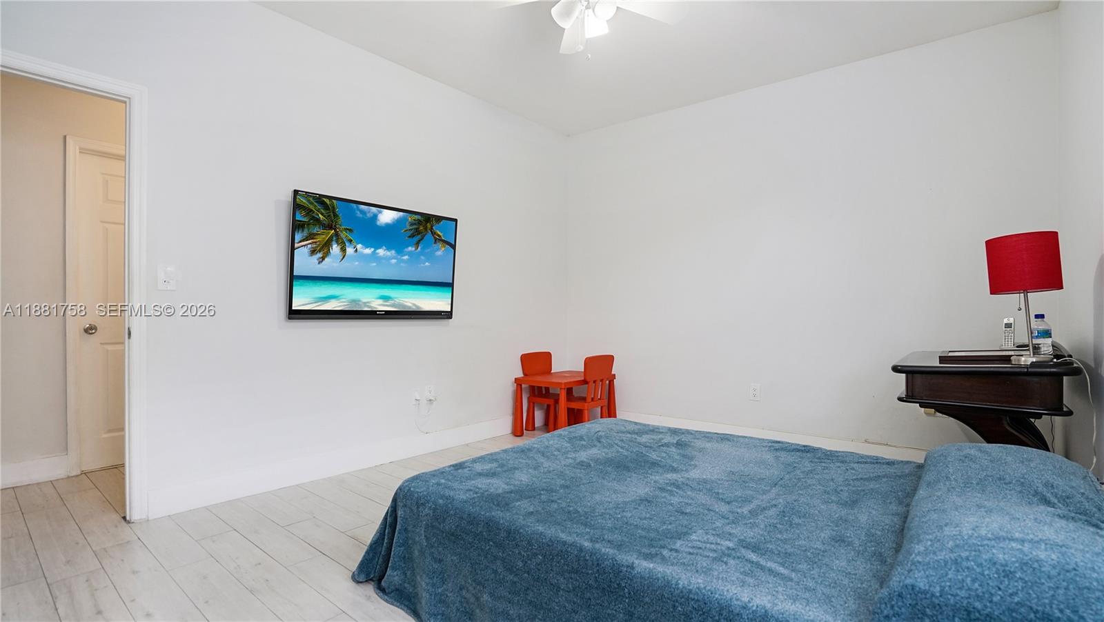 704 Northwest 129th Court Miami, FL 33182 - Photo 24 of 58 a bedroom with a bed and a painting on the wall