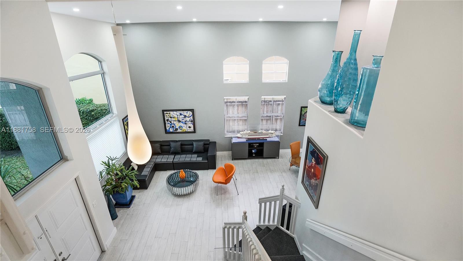 704 Northwest 129th Court Miami, FL 33182 - Photo 25 of 58 wooden floor view of living room with furniture and flat screen tv