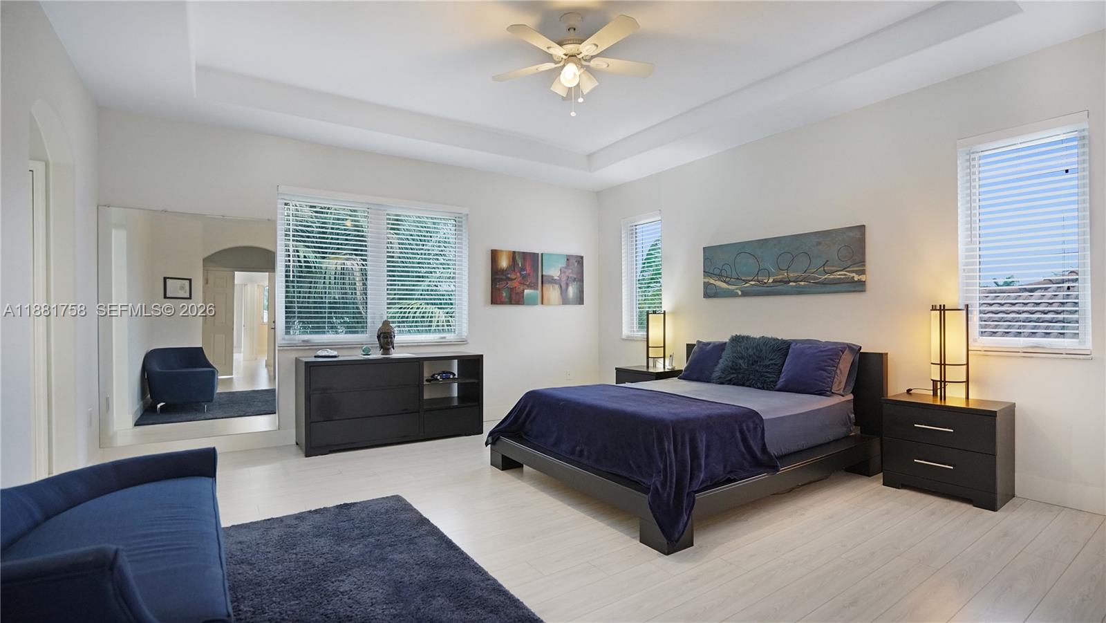 704 Northwest 129th Court Miami, FL 33182 - Photo 30 of 58 a spacious bedroom with a bed and glass window