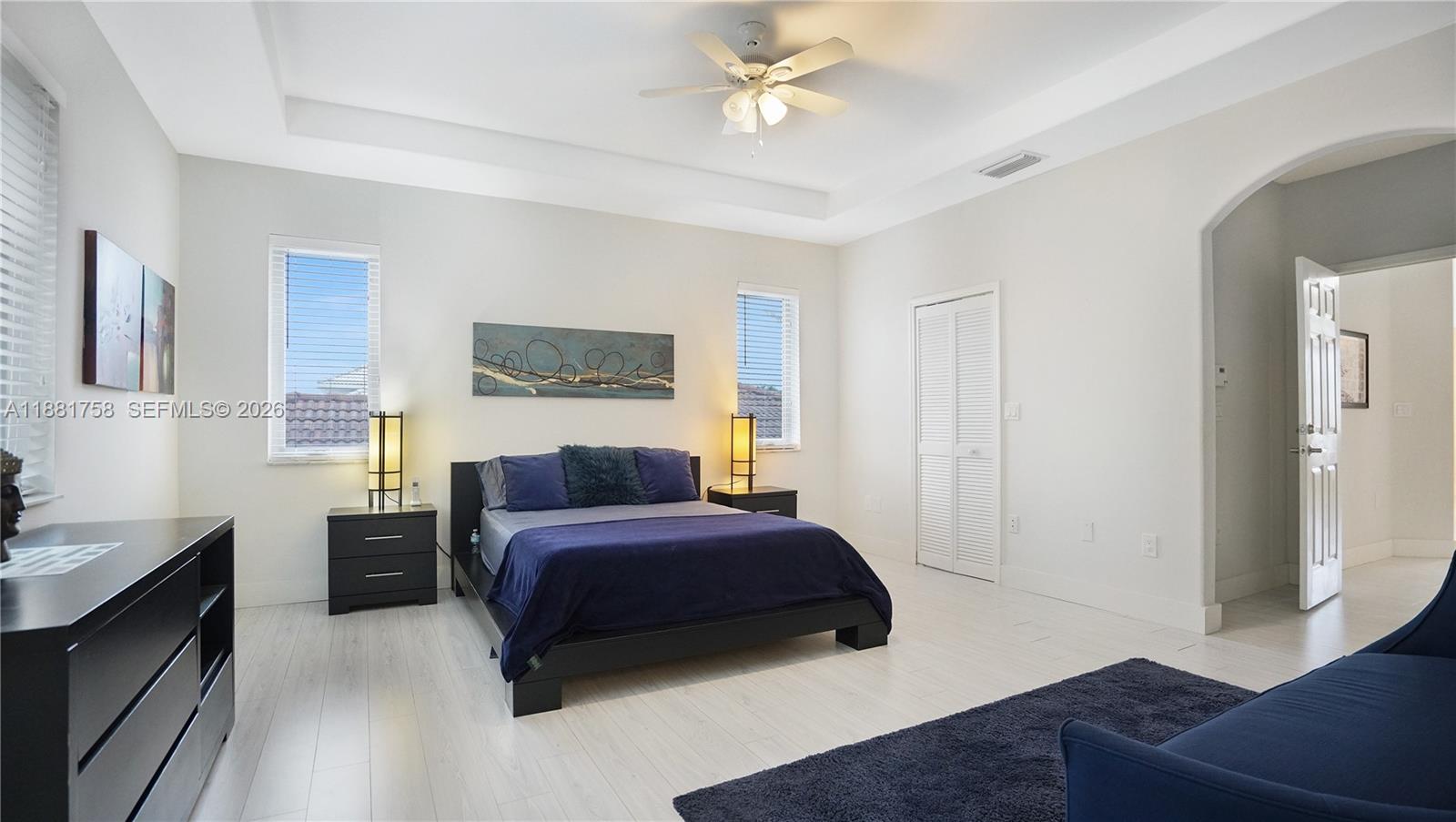 704 Northwest 129th Court Miami, FL 33182 - Photo 31 of 58 a bedroom with a bed couch and a window