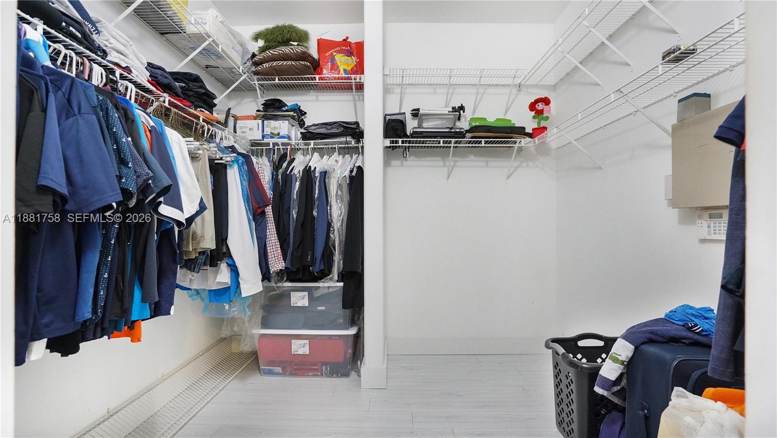 704 Northwest 129th Court Miami, FL 33182 - Photo 33 of 58 a view of walk in closet with clothes and shoes
