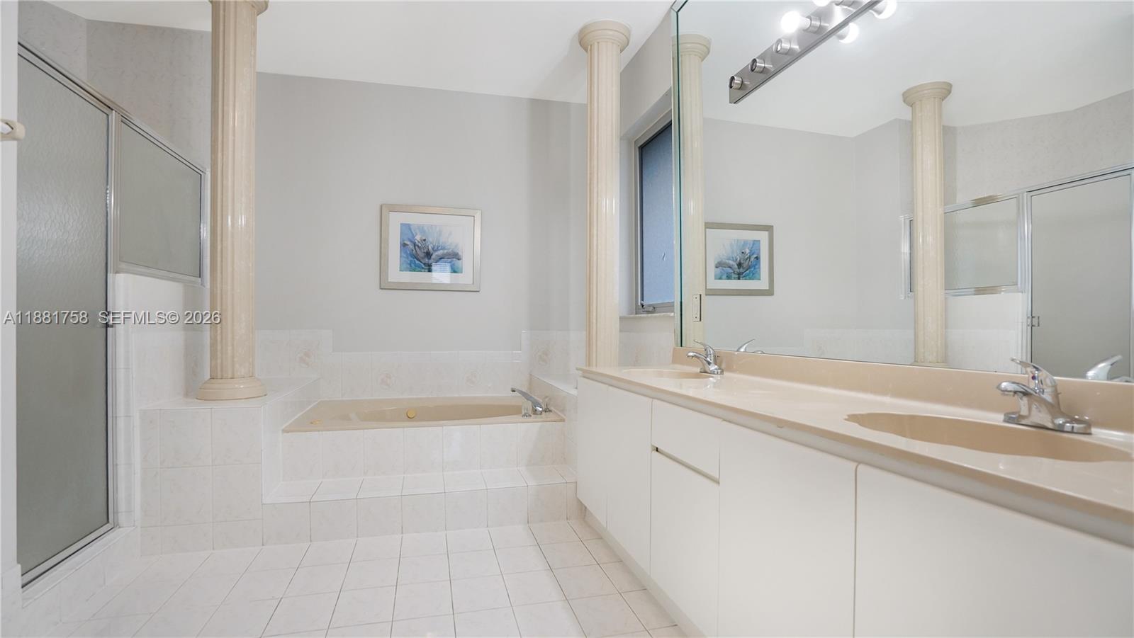 704 Northwest 129th Court Miami, FL 33182 - Photo 36 of 58 a bathroom with a tub sink and mirror