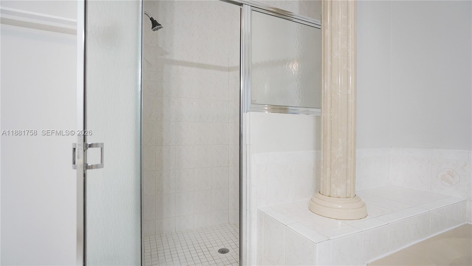 704 Northwest 129th Court Miami, FL 33182 - Photo 38 of 58 a bathroom with a glass shower door