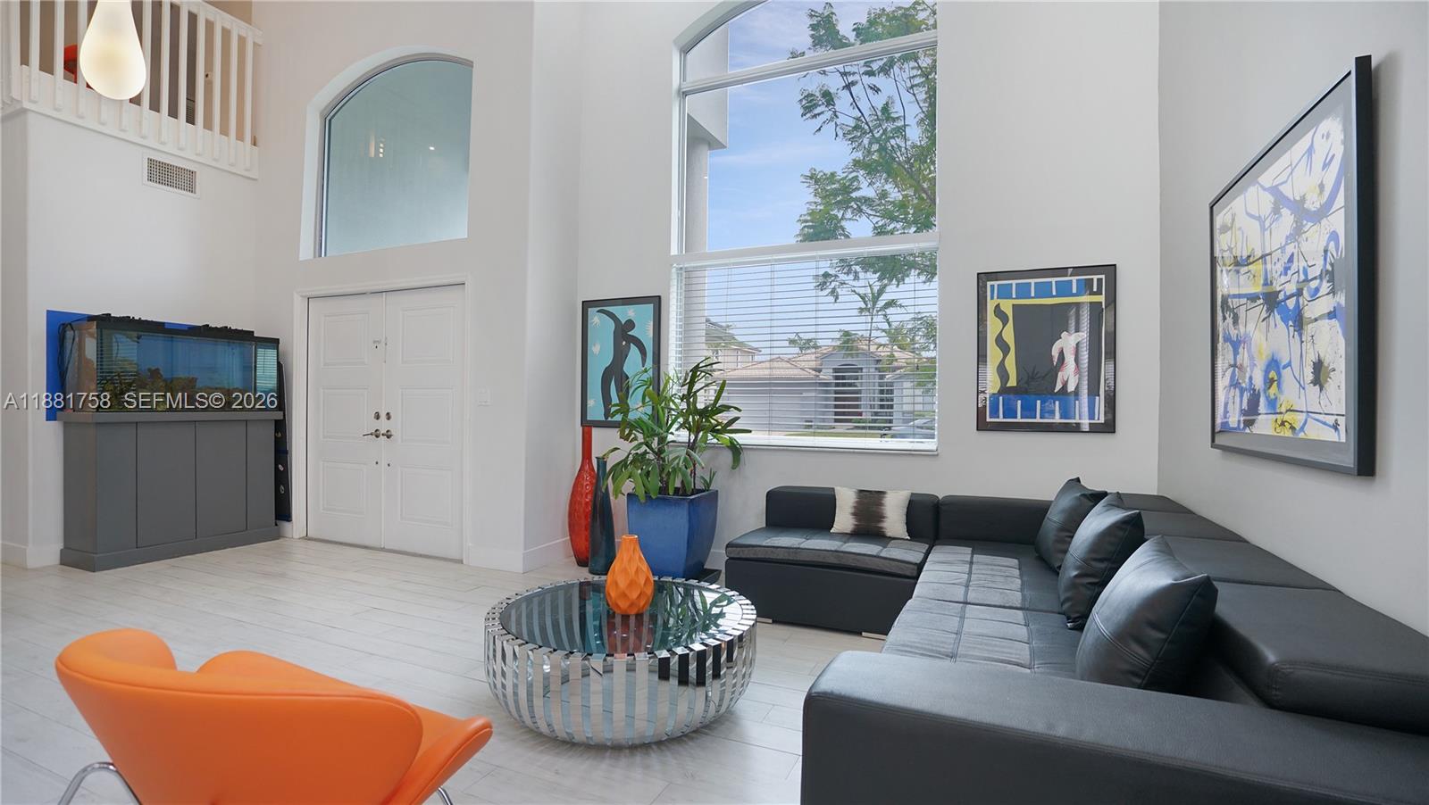 704 Northwest 129th Court Miami, FL 33182 - Photo 4 of 58 a living room with furniture and a potted plant
