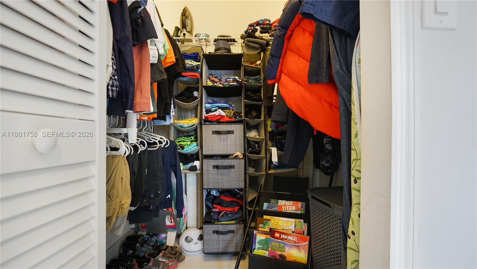 704 Northwest 129th Court Miami, FL 33182 - Photo 42 of 58 a view of walk in closet with clothes and shoes