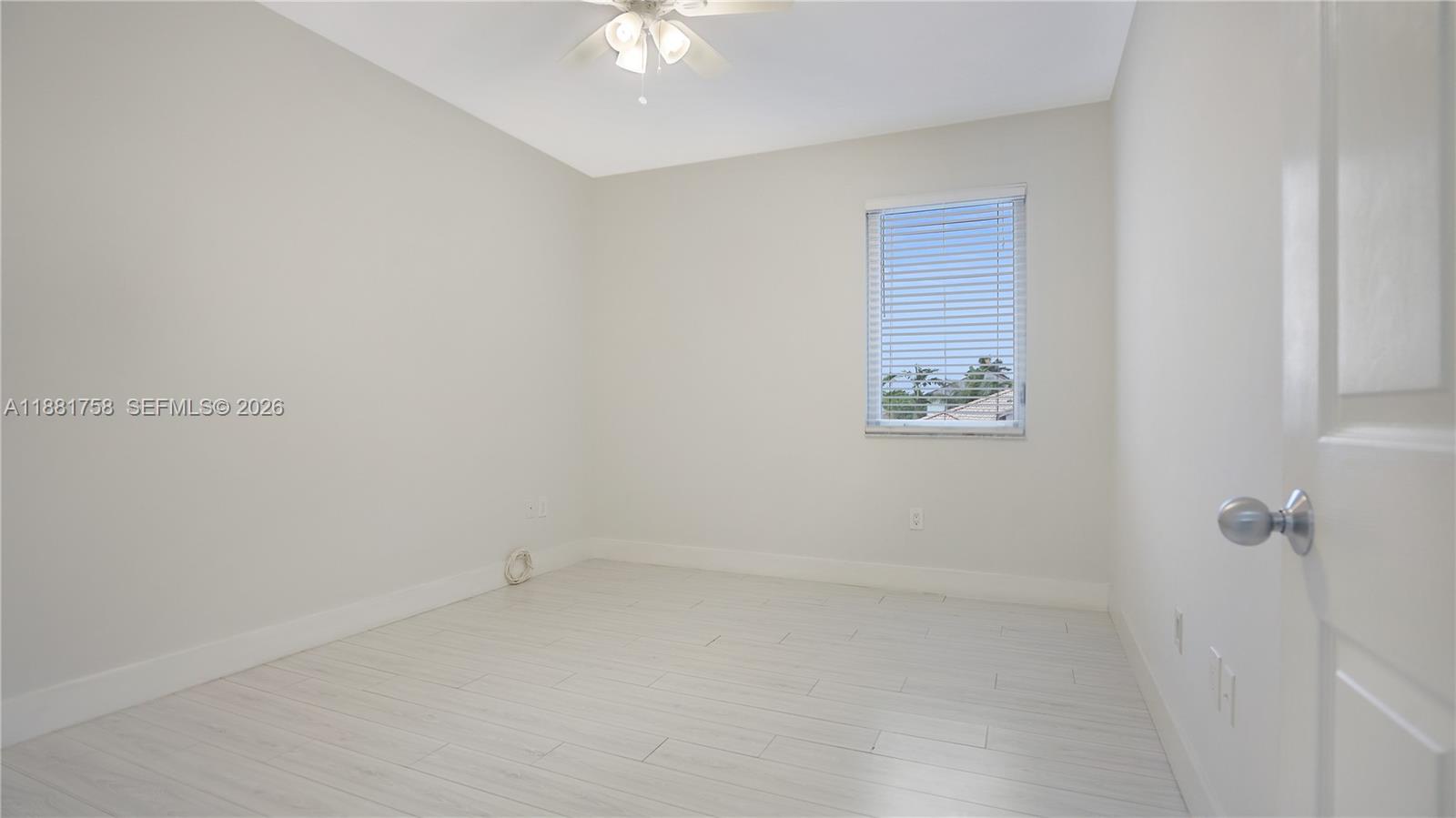 704 Northwest 129th Court Miami, FL 33182 - Photo 44 of 58 an empty room with a fan