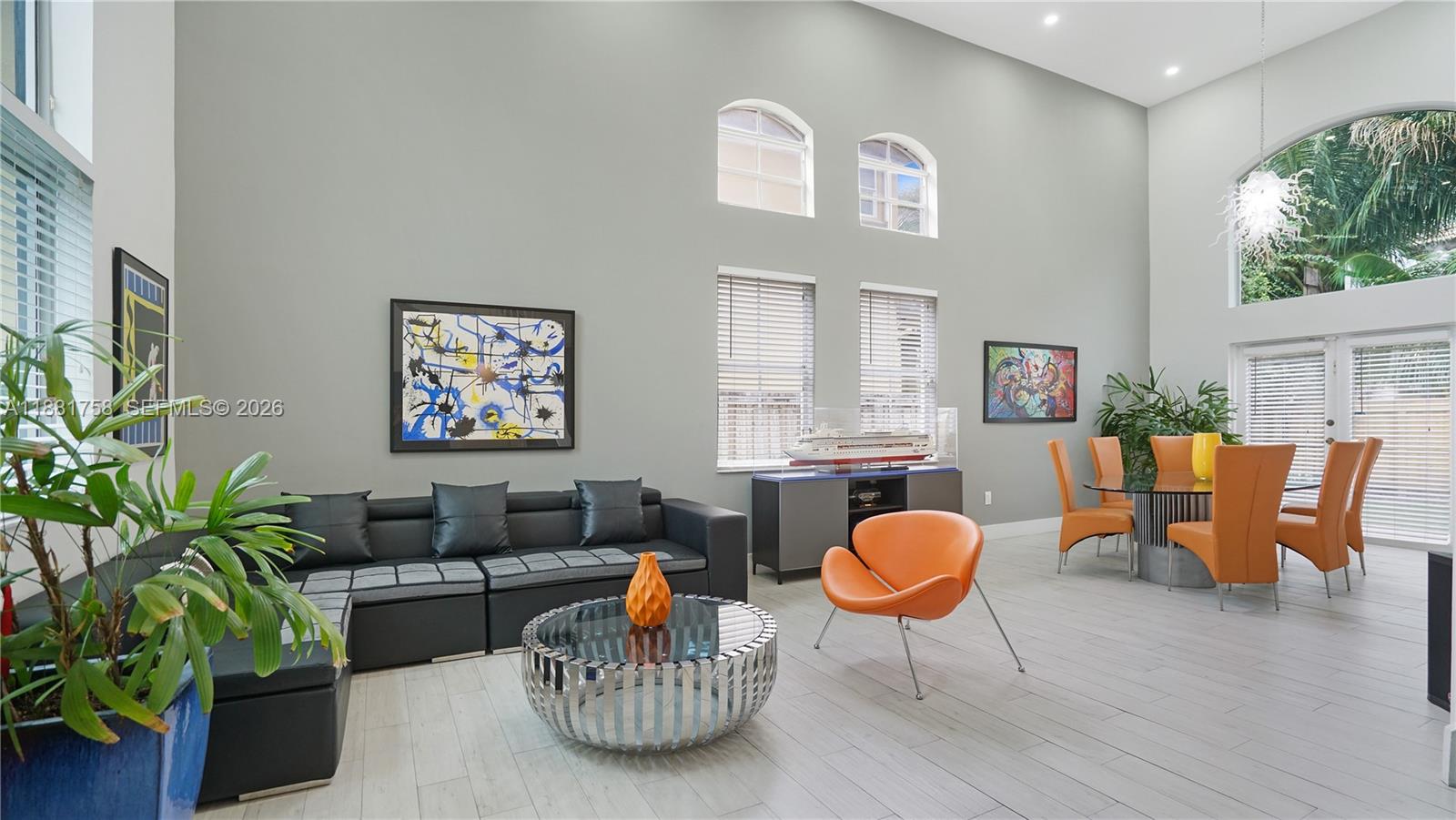 704 Northwest 129th Court Miami, FL 33182 - Photo 5 of 58 a living room with furniture a rug and a potted plant