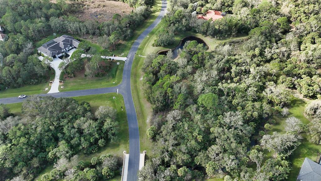 9255 Swaying Branch Road Sarasota, FL 34241 - Photo 18 of 23 an aerial view of a house with a yard