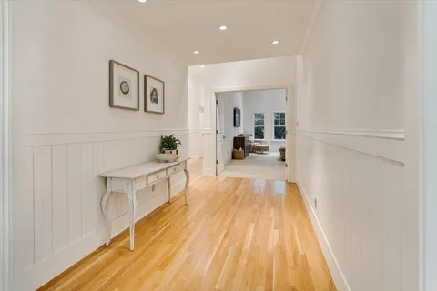 a view of a living room hardwood and kitchen