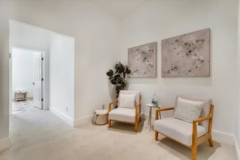 a living room with furniture and white walls