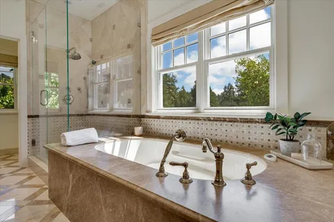 a bathroom with a granite countertop sink and a window