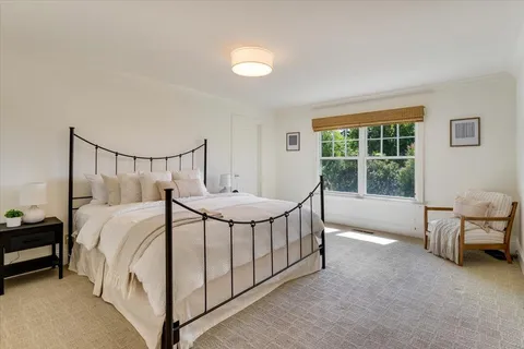 a bed sitting in a room next to a window