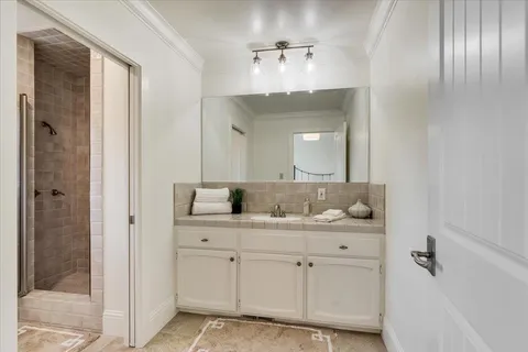 a bathroom with a double vanity sink and shower