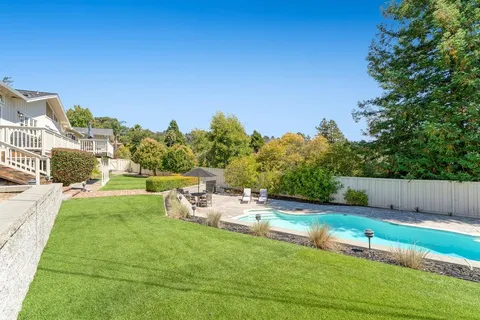 a view of a backyard with sitting area