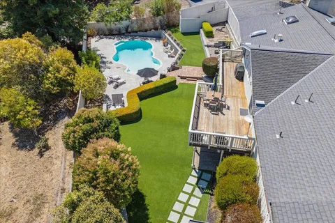 an aerial view of a house with outdoor space