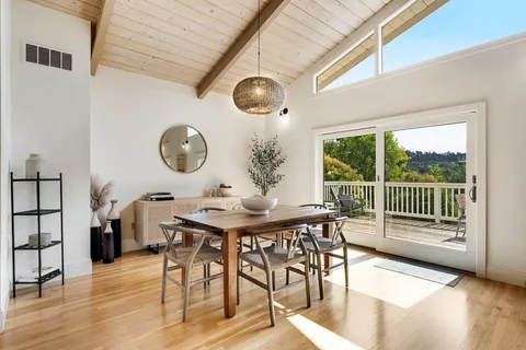 a view of a dining room with furniture and a large window