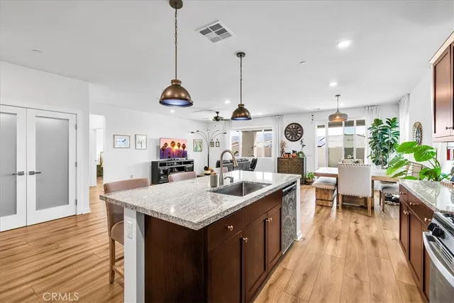 a kitchen with a counter space dining table and wooden floor