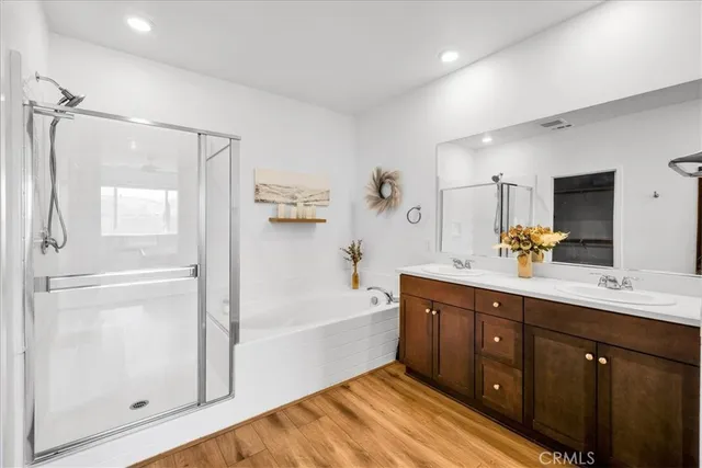 a spacious bathroom with a tub sink shower and mirror
