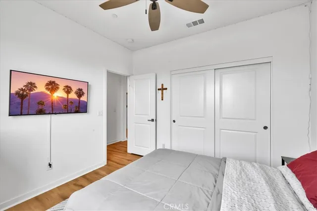 a bedroom with a bed and a painting on the wall