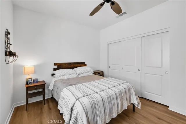 a bedroom with a bed and wooden floor