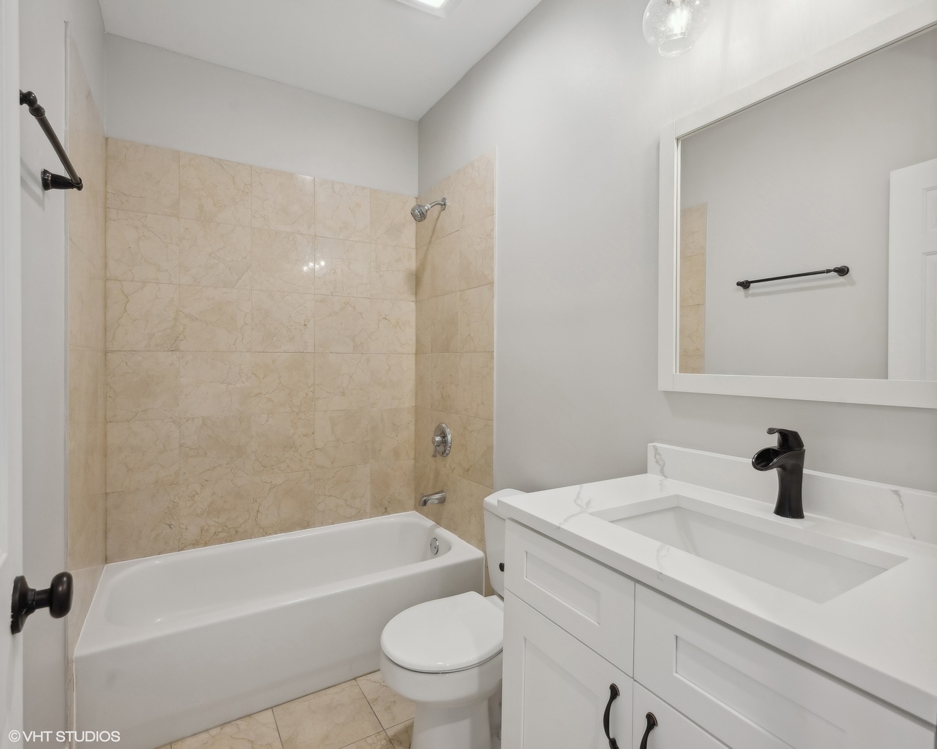 116 South Bell Avenue, Unit 1 Chicago, IL 60612 - Photo 16 of 30 a bathroom with a sink a toilet a mirror a bathtub and shower