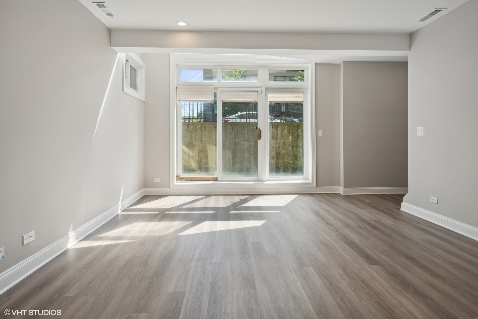 116 South Bell Avenue, Unit 1 Chicago, IL 60612 - Photo 20 of 30 an empty room with wooden floor and windows