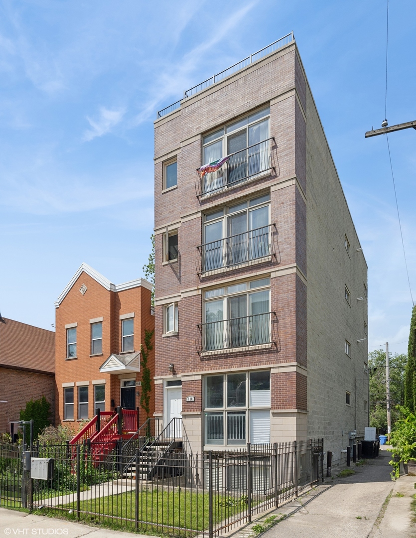 116 South Bell Avenue, Unit 1 Chicago, IL 60612 - Photo 2 of 30 a view of a brick building next to a yard