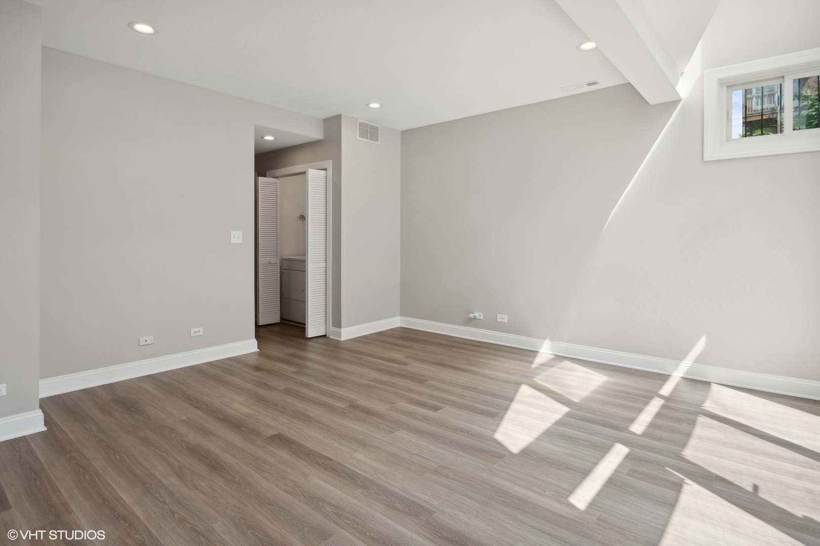 116 South Bell Avenue, Unit 1 Chicago, IL 60612 - Photo 22 of 30 a view of an empty room with wooden floor and a window