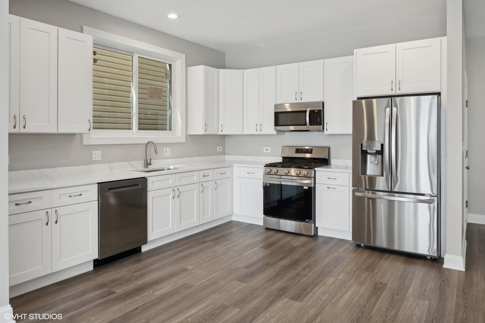 116 South Bell Avenue, Unit 1 Chicago, IL 60612 - Photo 3 of 30 a kitchen with white cabinets and white stainless steel appliances