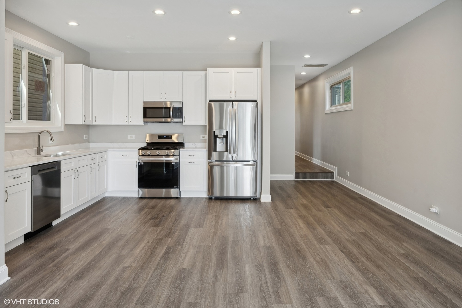 116 South Bell Avenue, Unit 1 Chicago, IL 60612 - Photo 5 of 30 a kitchen with wooden floors and stainless steel appliances