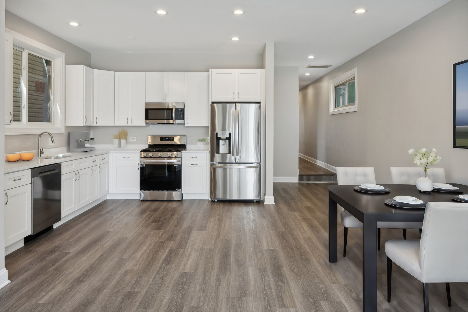 116 South Bell Avenue, Unit 1 Chicago, IL 60612 - Photo 6 of 30 a kitchen with a wooden floor a refrigerator and a stove