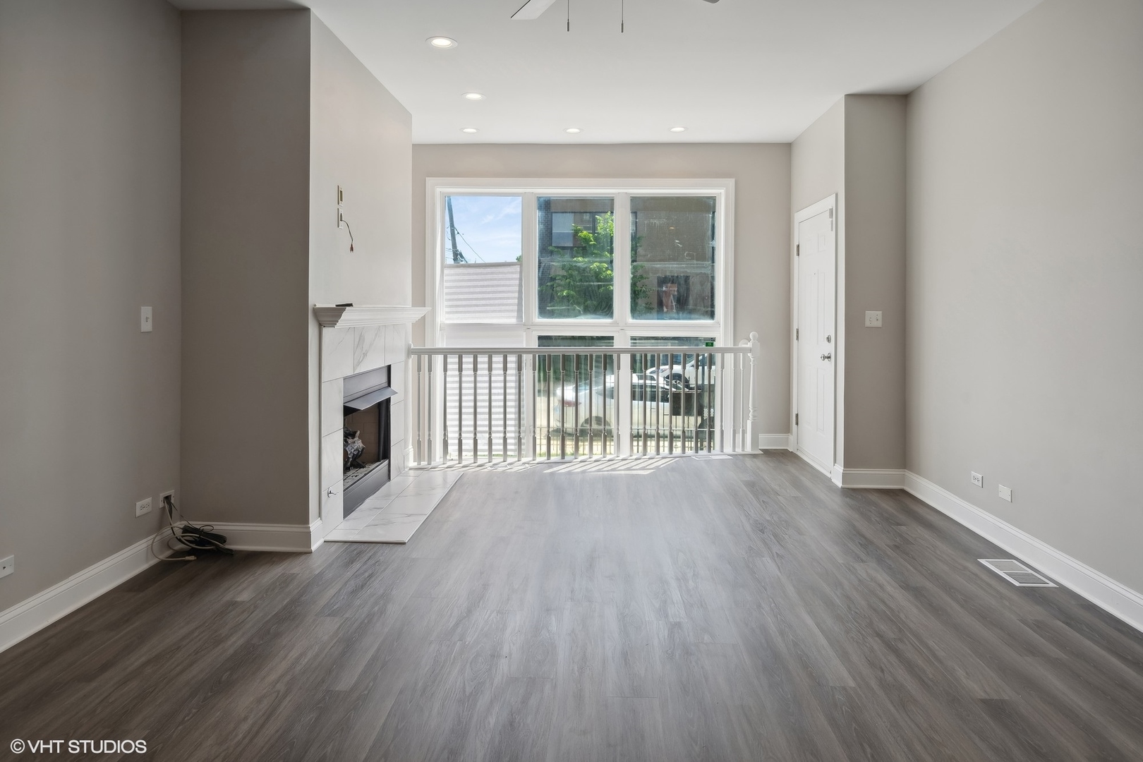 116 South Bell Avenue, Unit 1 Chicago, IL 60612 - Photo 7 of 30 an empty room with wooden floor and windows