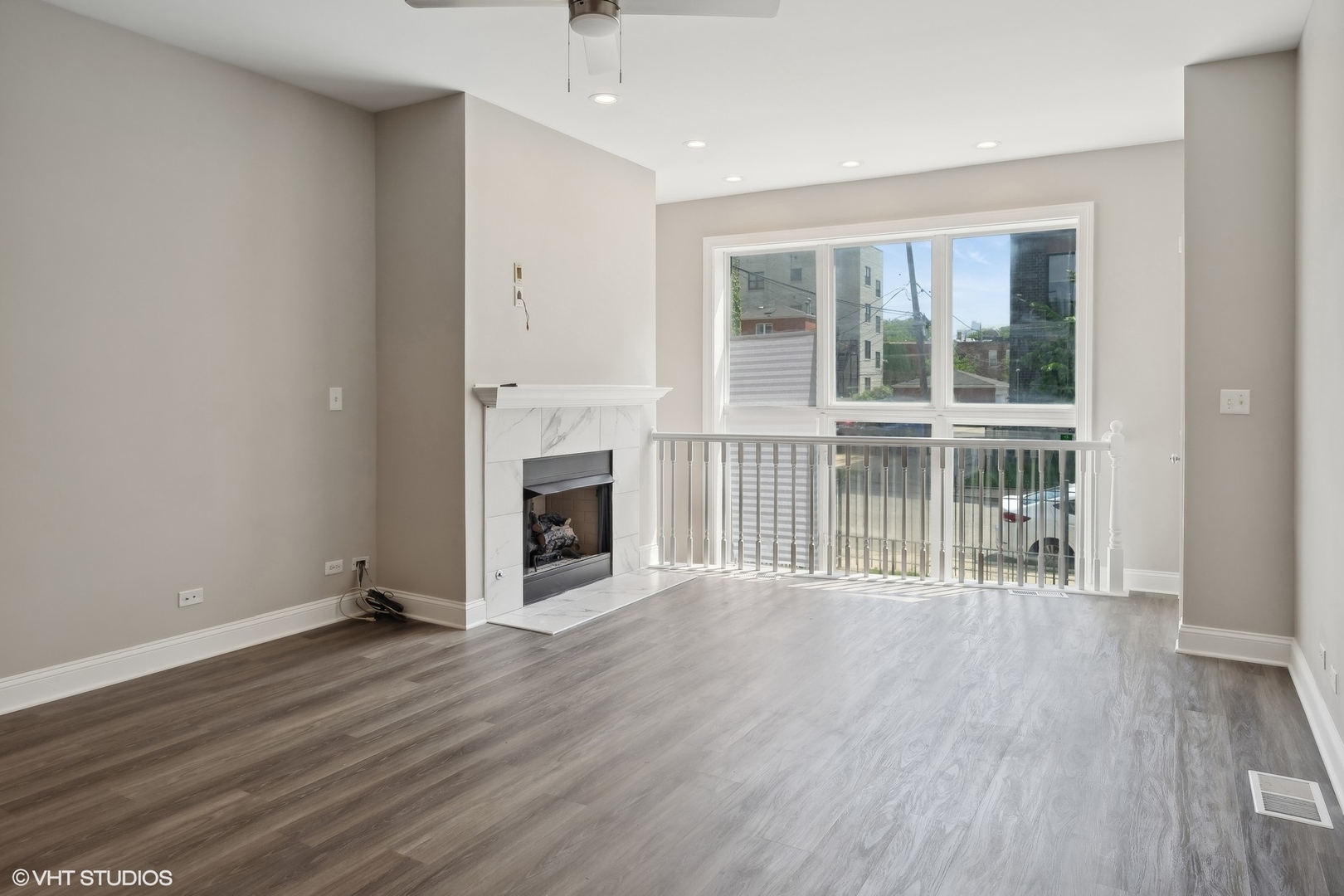 116 South Bell Avenue, Unit 1 Chicago, IL 60612 - Photo 8 of 30 an empty room with wooden floor and fireplace