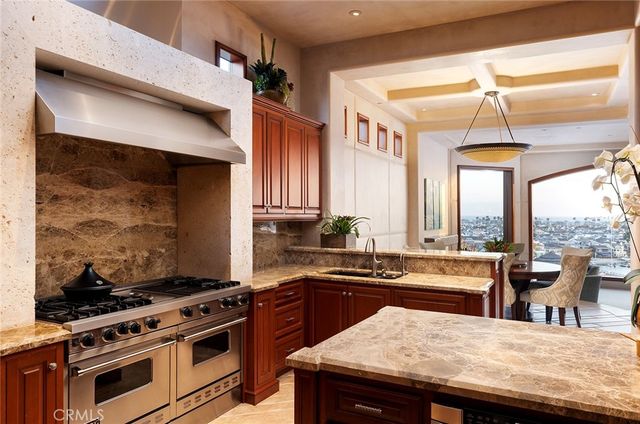 a kitchen with stainless steel appliances granite countertop a stove and a sink