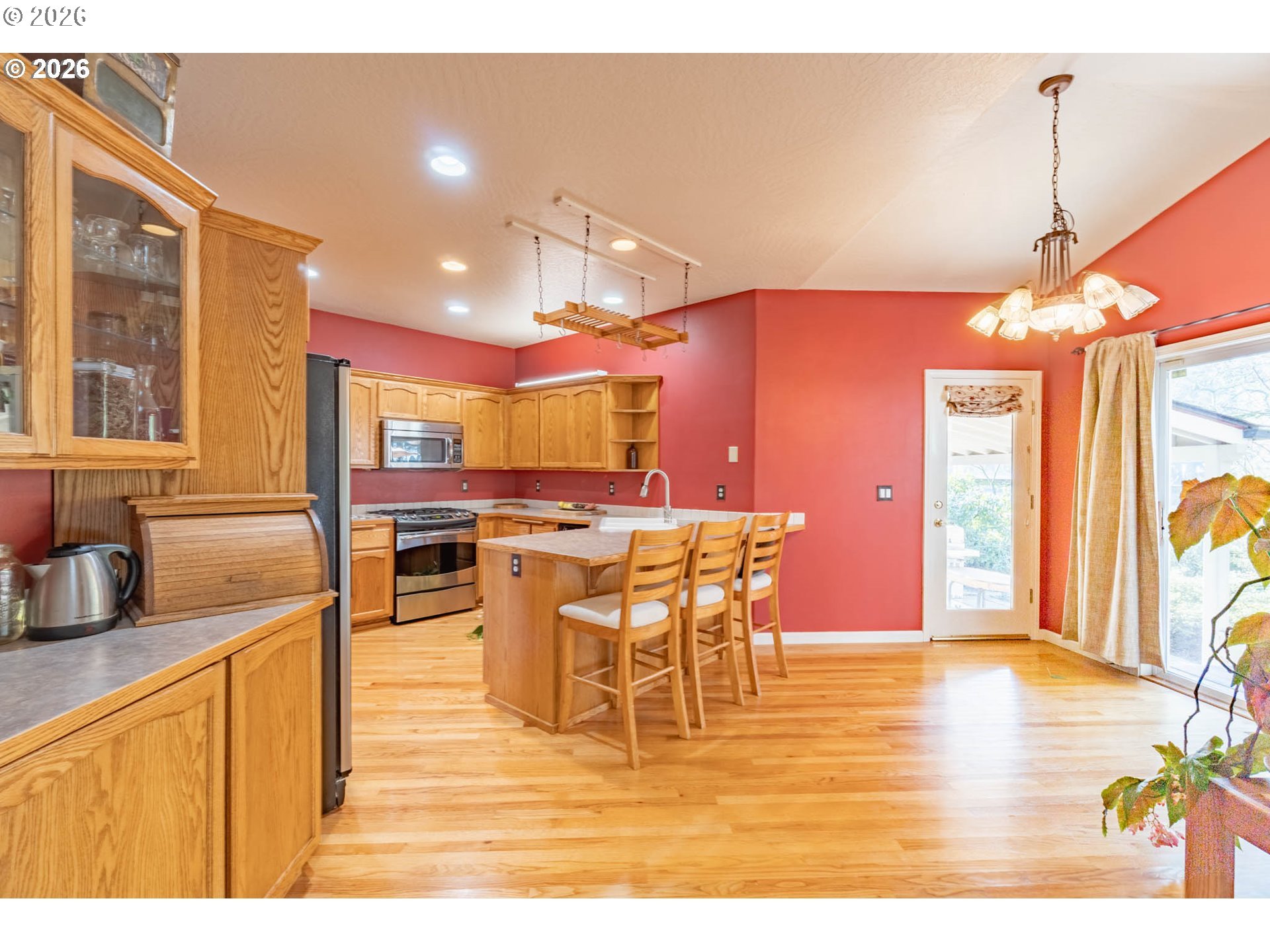 4366 Berry Lane Eugene, OR 97404 - Photo 13 of 36 a view of a dining room and livingroom with furniture wooden floor a rug a flat screen tv