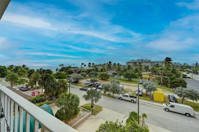 a view of a swimming pool with a table and chairs under an umbrella